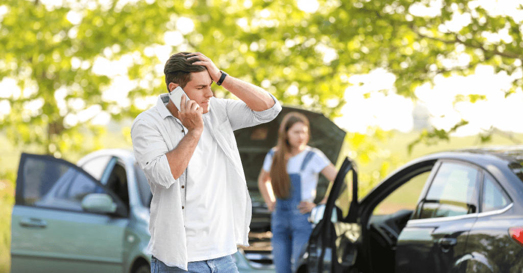 Man calling a car accident lawyer following a wreck.