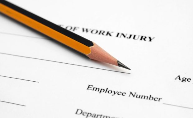 Employee fills out workers' compensation form after injury on the job