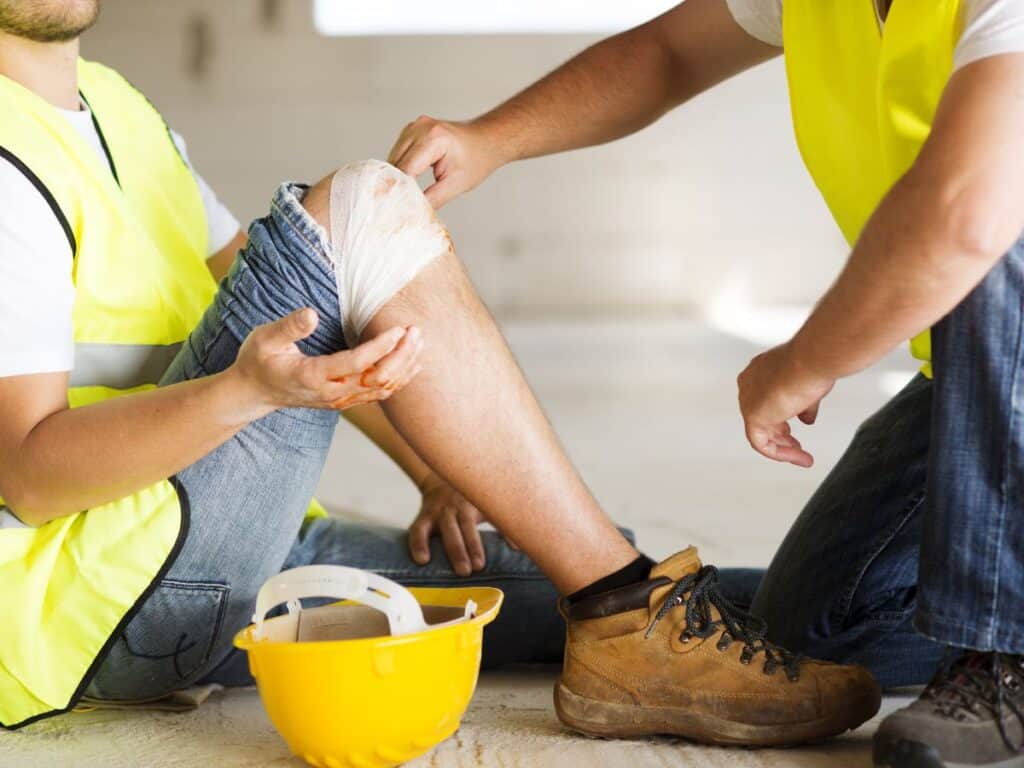 someone has an injured knee at a construction site
