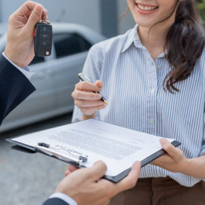 Close-up of someone accepting rental car keys after an accident, symbolizing recovery and ongoing travel.